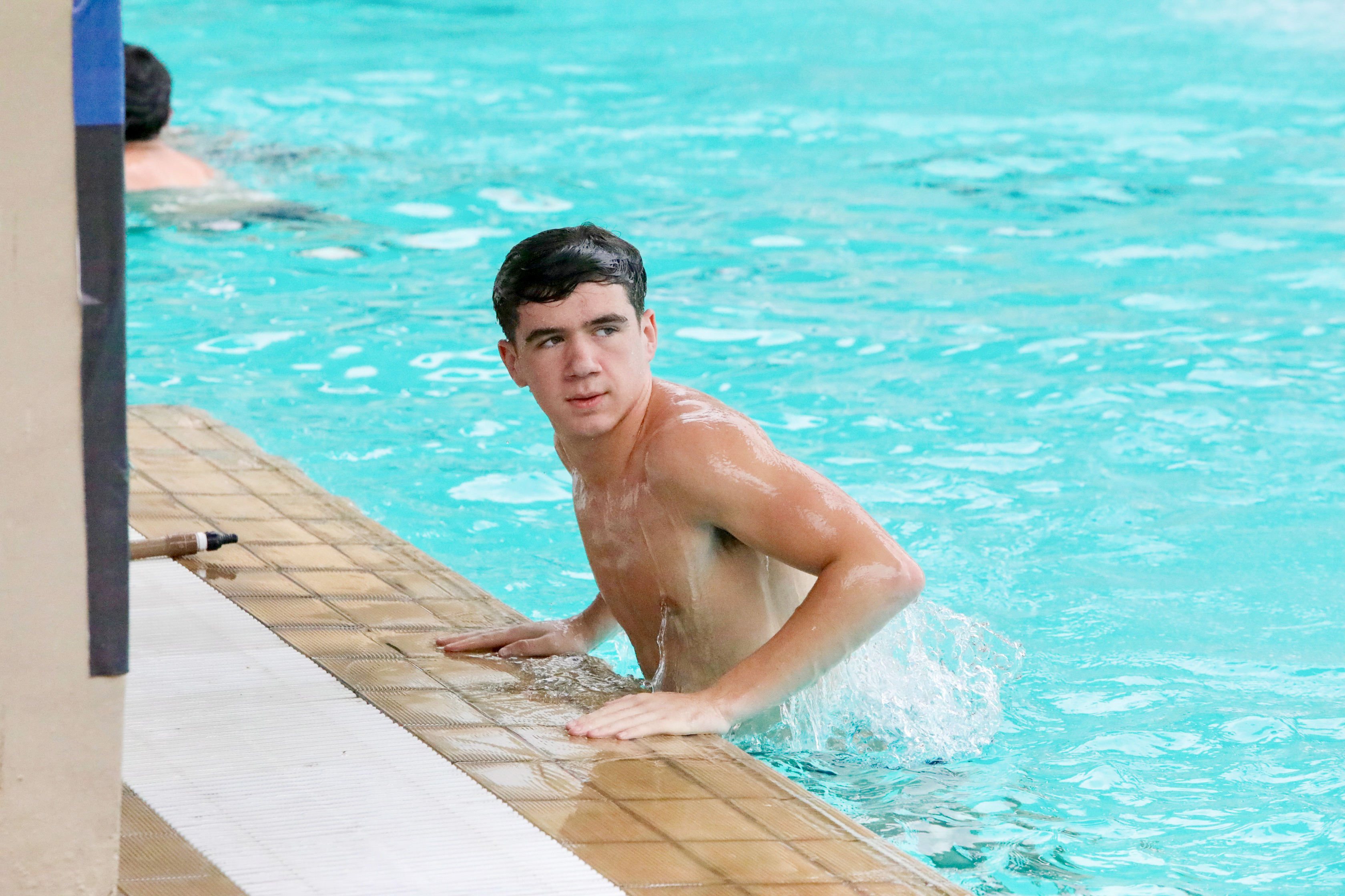 Woodson senior Nathaniel Grannis, who participated in the U.S. Olympic trials last summer, gets out of the pool during dive practice.